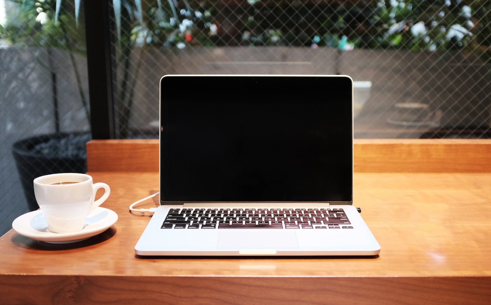 laptop computer beside coffee